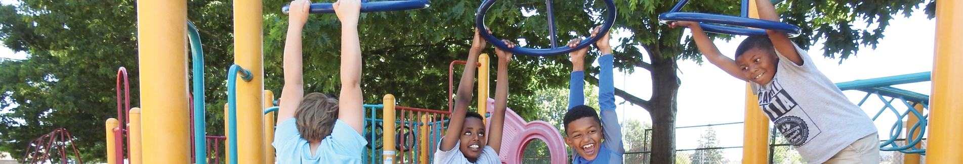 School age children playing on the jungle gym at a playground