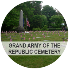 Grand Army of the Republic Cemetary - Photo: The cemetery, with American flags placed at every grave, in from of a large monument.