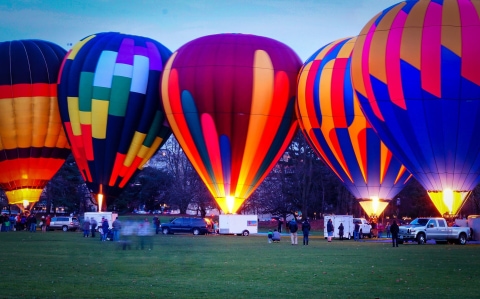 Colorful hot air balloons at twilight during Pathway of Lights at Green Lake