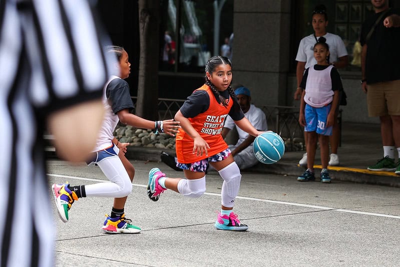 Girl playing basketball in Seattle streets