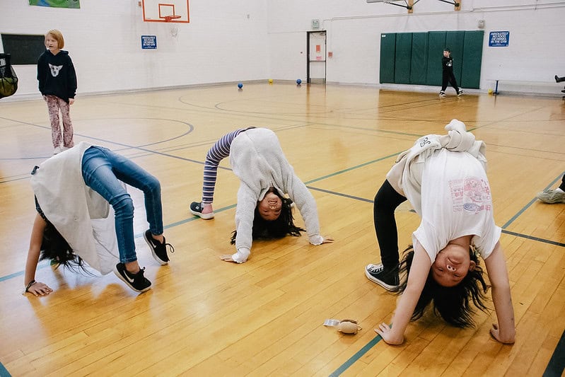 Kids doing backbends in a gym